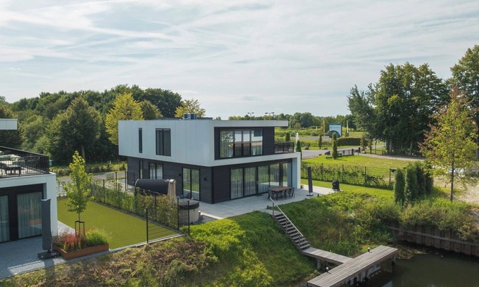 Zeewolde House | Enjoy luxury at holiday villa Maan: a 10-person villa with a hot tub, sauna, and waterfront terrace. Modern and spacious, ideal for a relaxing holiday!