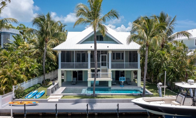Stillwright Point House | Luxurious tropical water-front Heated pool home with Boat Dock and two master .
