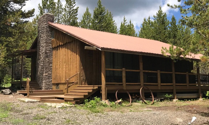 Island Park Cabin | Porch lined cabin nestled in the Pines for lazy summer days