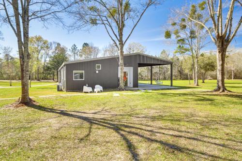 Latimer Apartment | Porch with Swing and Kayaks Rural Mississippi Retreat