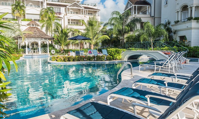 Schooner Bay Apartment | Schooner bay is a beachfront condominium with a freeform swimming pool as the focal point