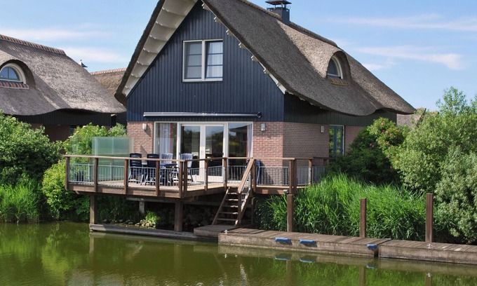 Makkum Villa | Thatched villa with terrace on the water at a holiday park in Friesland