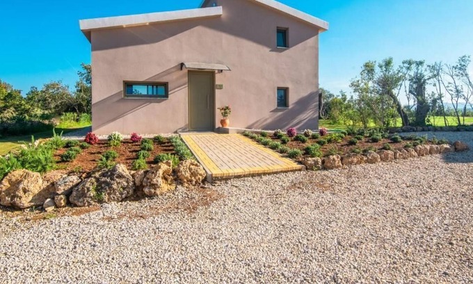 Ano Korakiana Villa | The villa's large private garden leads directly to the outdoor private pool.