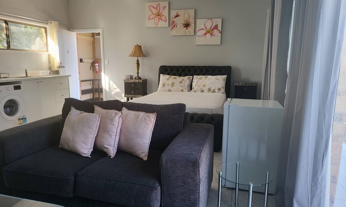 Windsor Apartment | Top View Deluxe Self-Contained Room No 3 with Balcony Overlooking Swimming Pool.